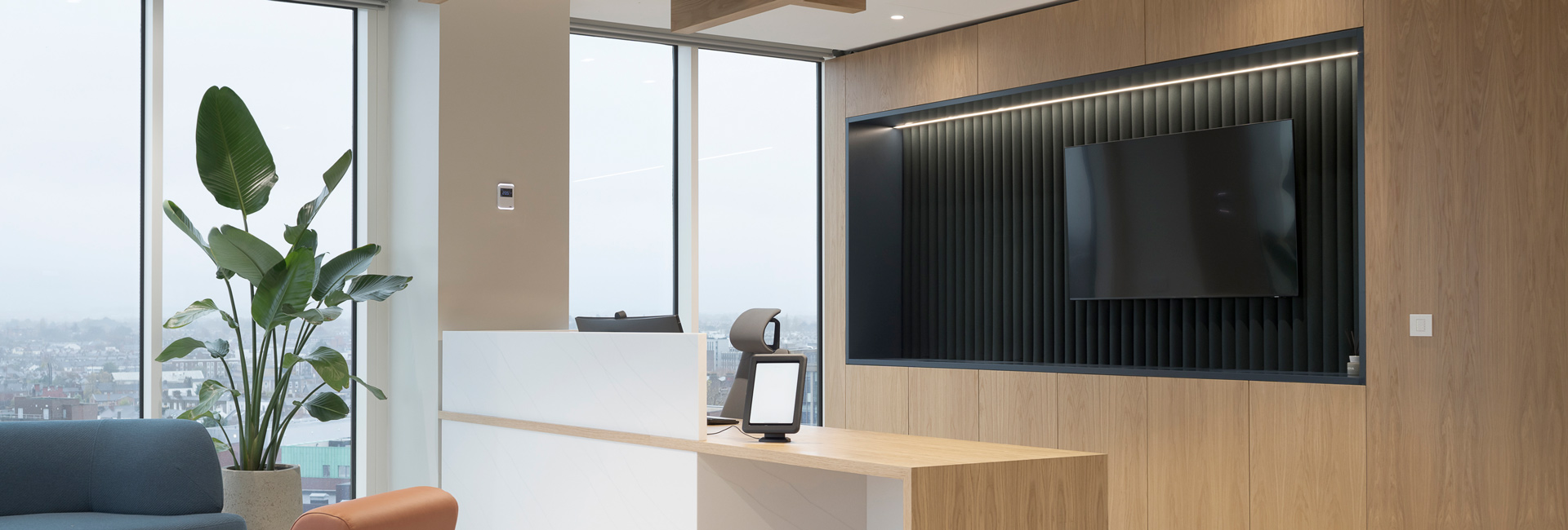 A reception desk next to large windows and a seating area