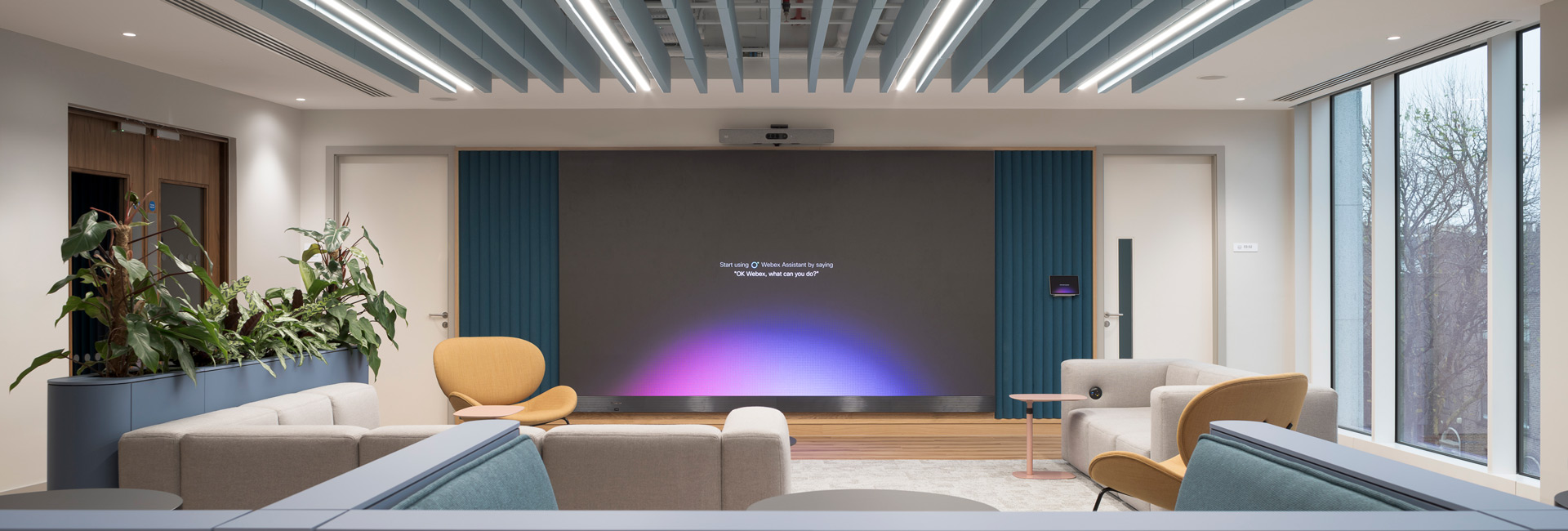 An open seating area with a large digital screen