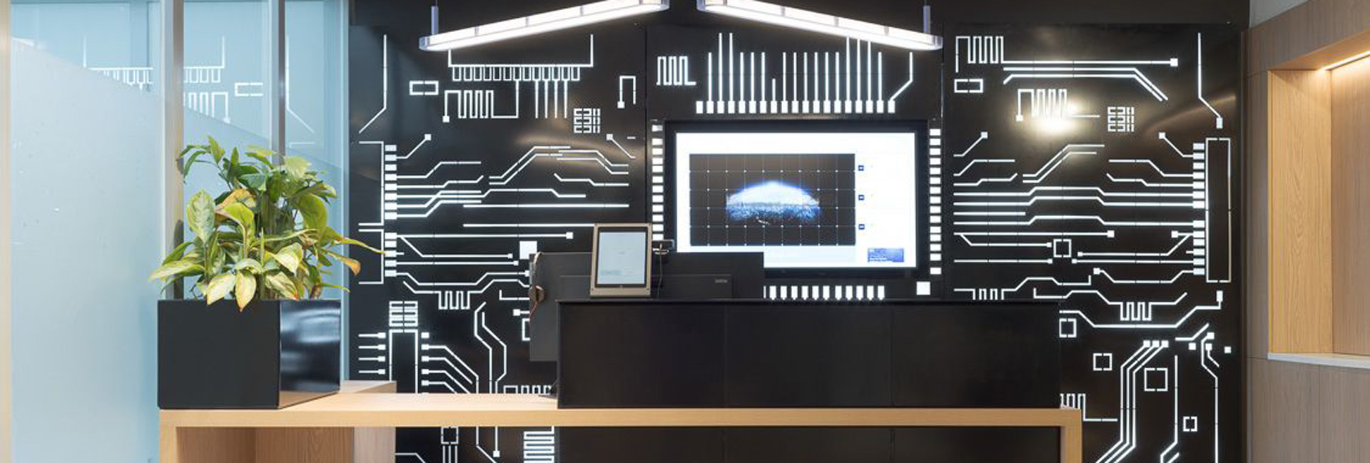 A reception desk in front of a stylish black and white wall, creating a modern and professional atmosphere.