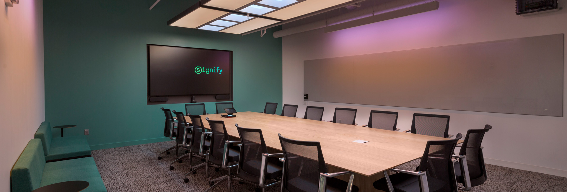 A large conference room with a long table and meeting chairs.