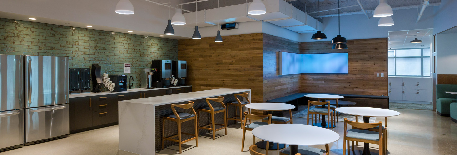 Kitchen area with tables and chairs for employees to use.