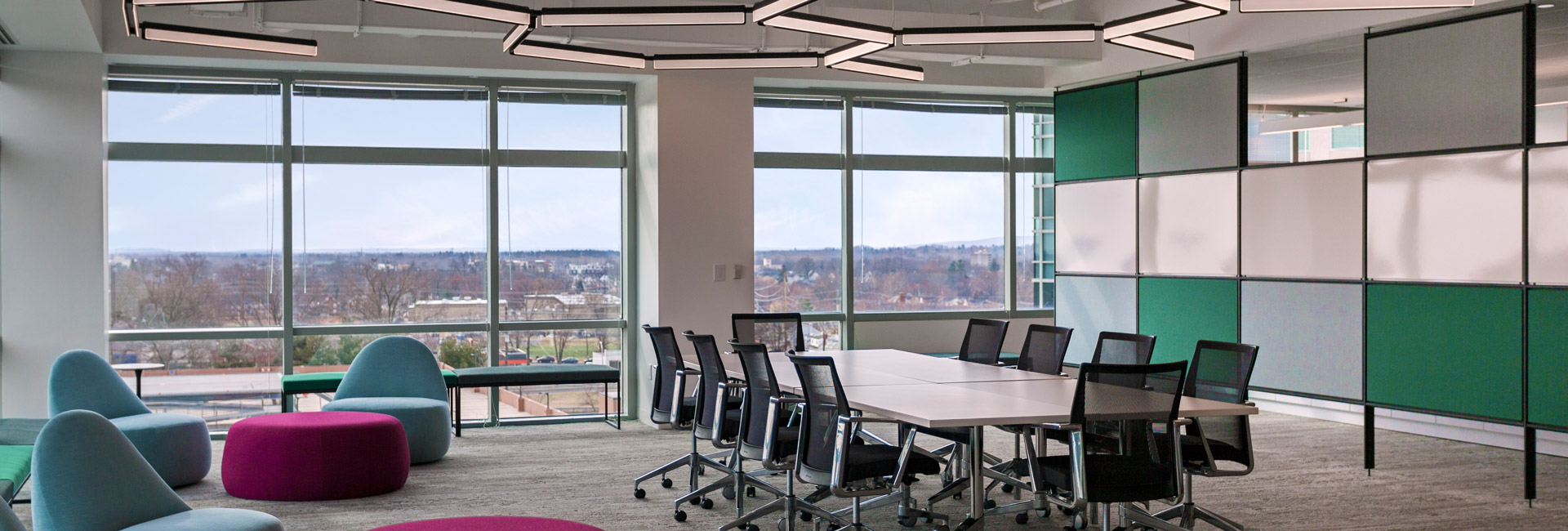 An open area with a large table with chairs for employees to use.