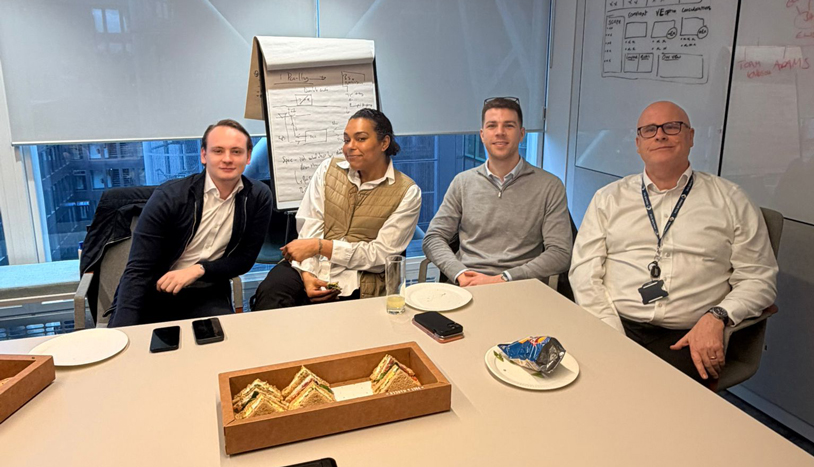 Employees sitting around a conference room table
