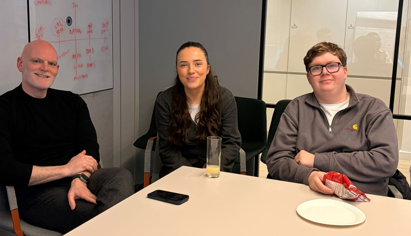 Employees sitting around a conference room table