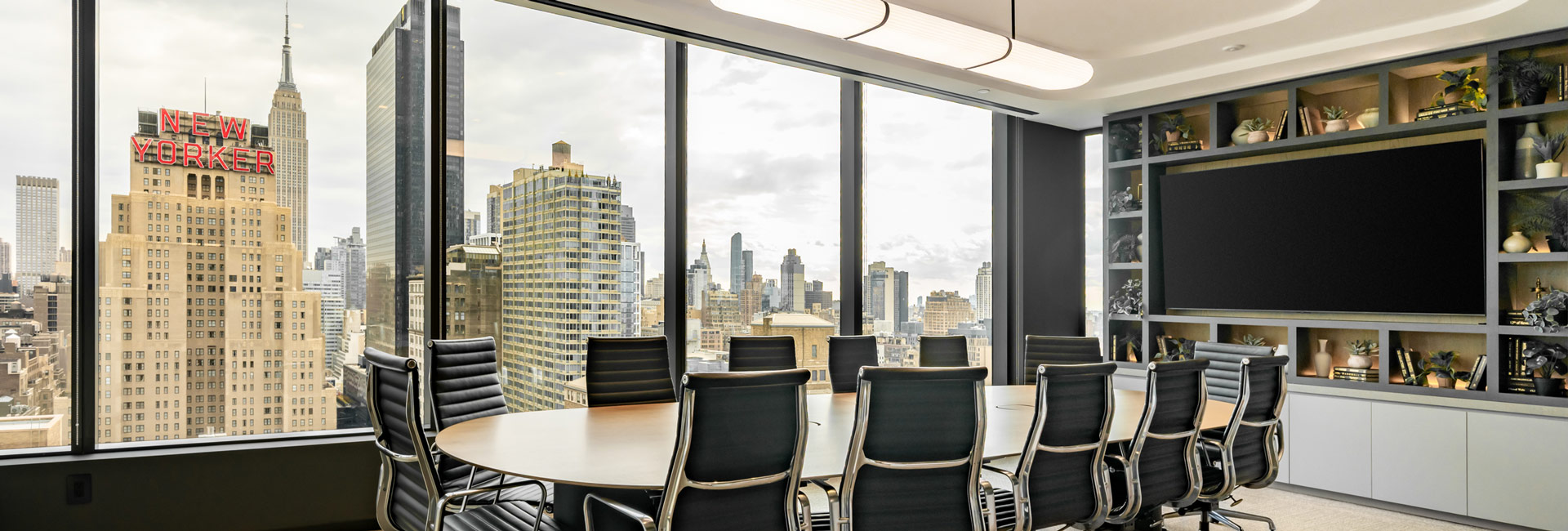A large conference room with windows overlooking the city skyline.