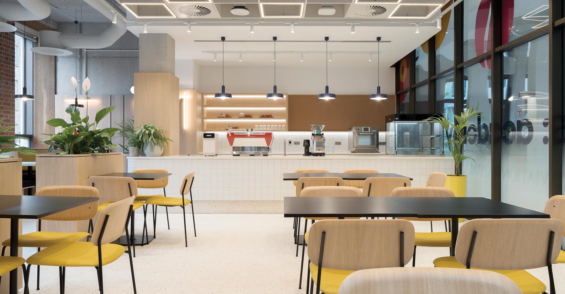 A cafe area with several tables and chairs
