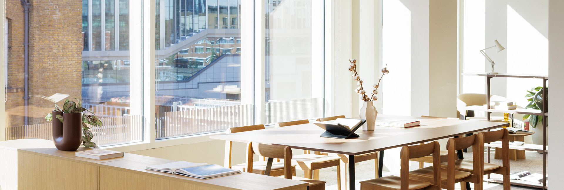 A desk next to large windows