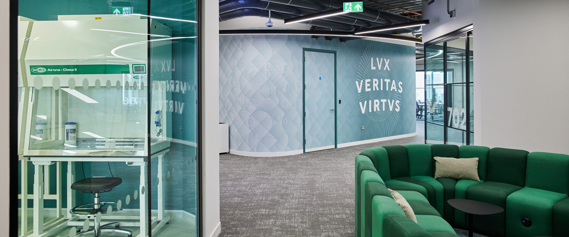 Hallway of Northeastern University with blue walls and glass doors.