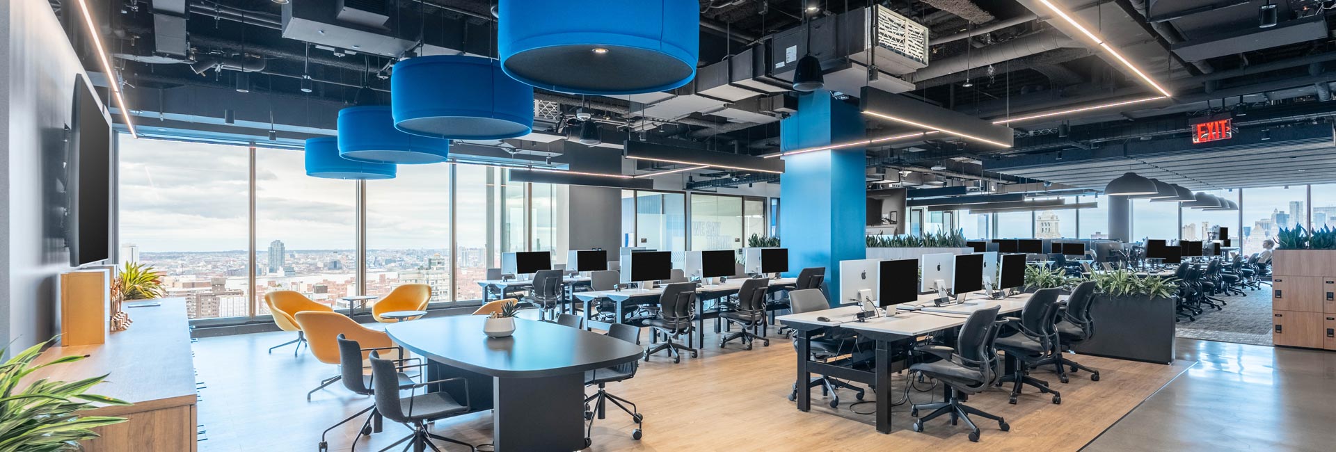 A large open office area with several desks and chairs