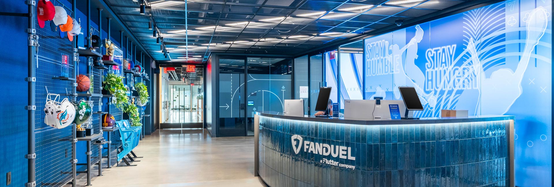 A large reception desk with a LED displays