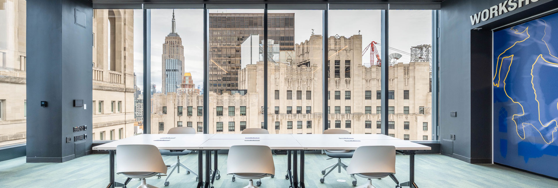 A large conference room with a view of the city skyline