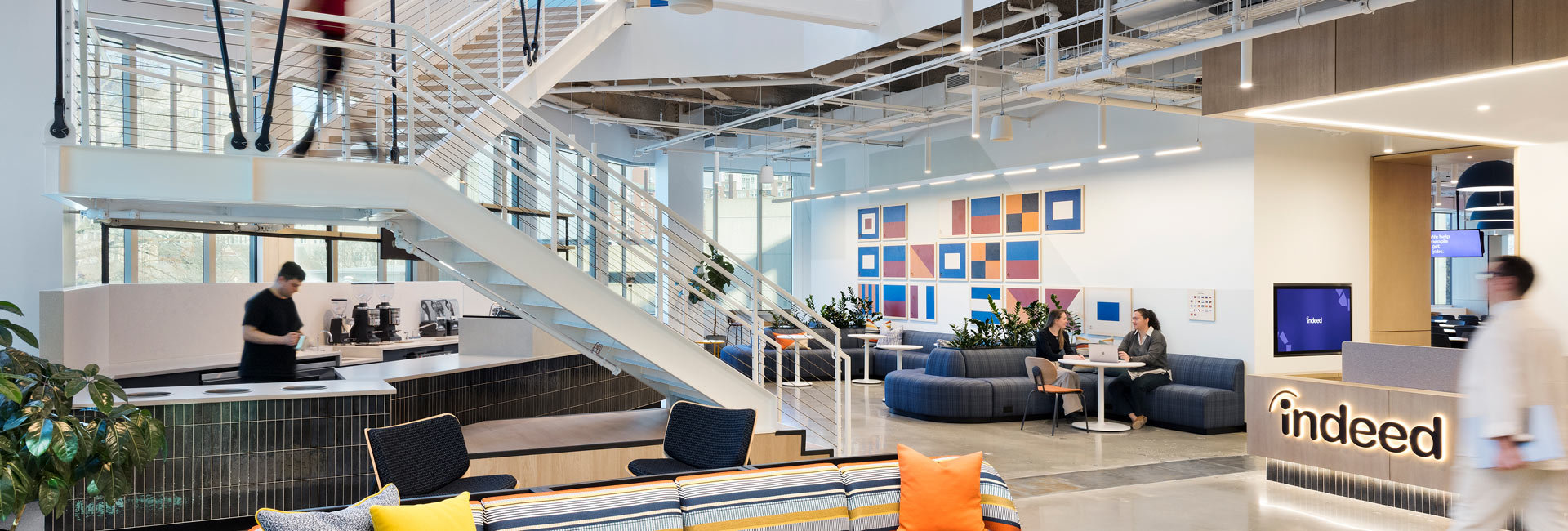 Open office space with a staircase and several places of seating.
