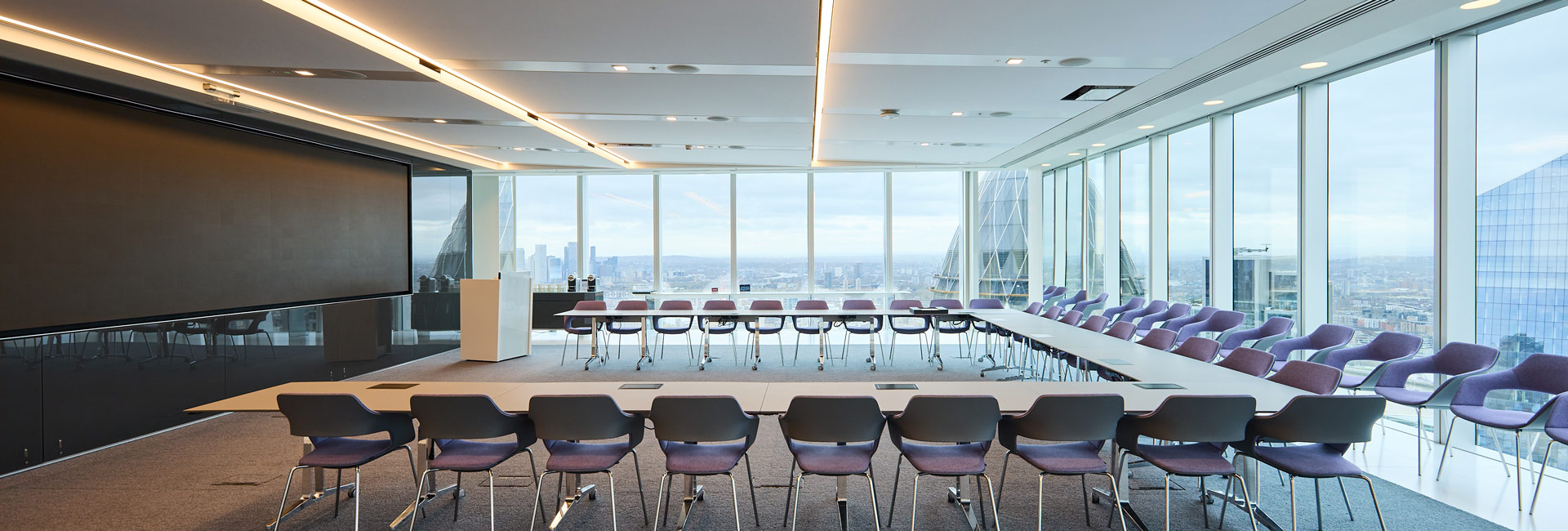 A large conference room with several tables and chairs to use.