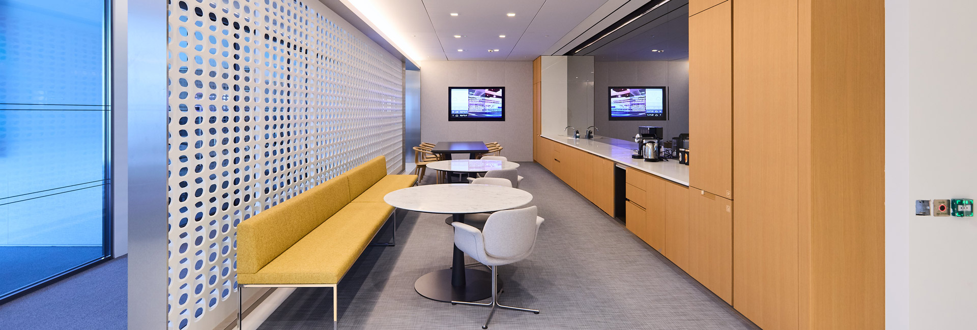 A few sitting area for employees to use next to a coffee station.