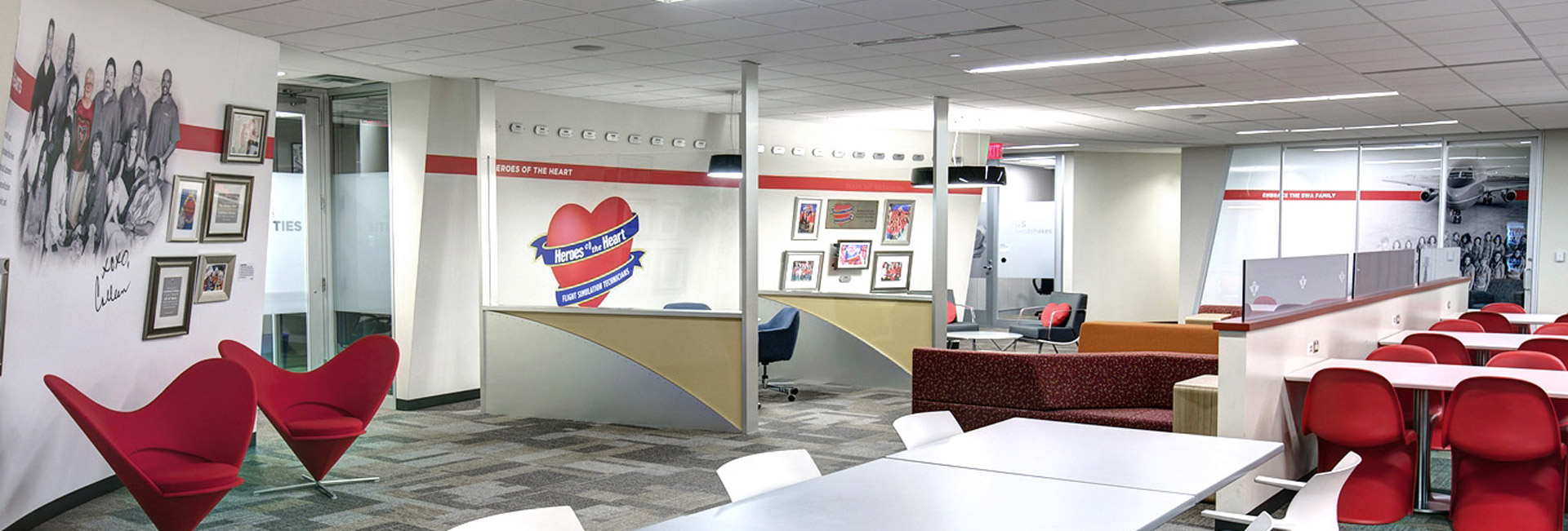 Modern, open-concept workspace at Southwest Airlines headquarters featuring collaborative seating, branded décor, employee recognition displays, and flexible meeting areas.