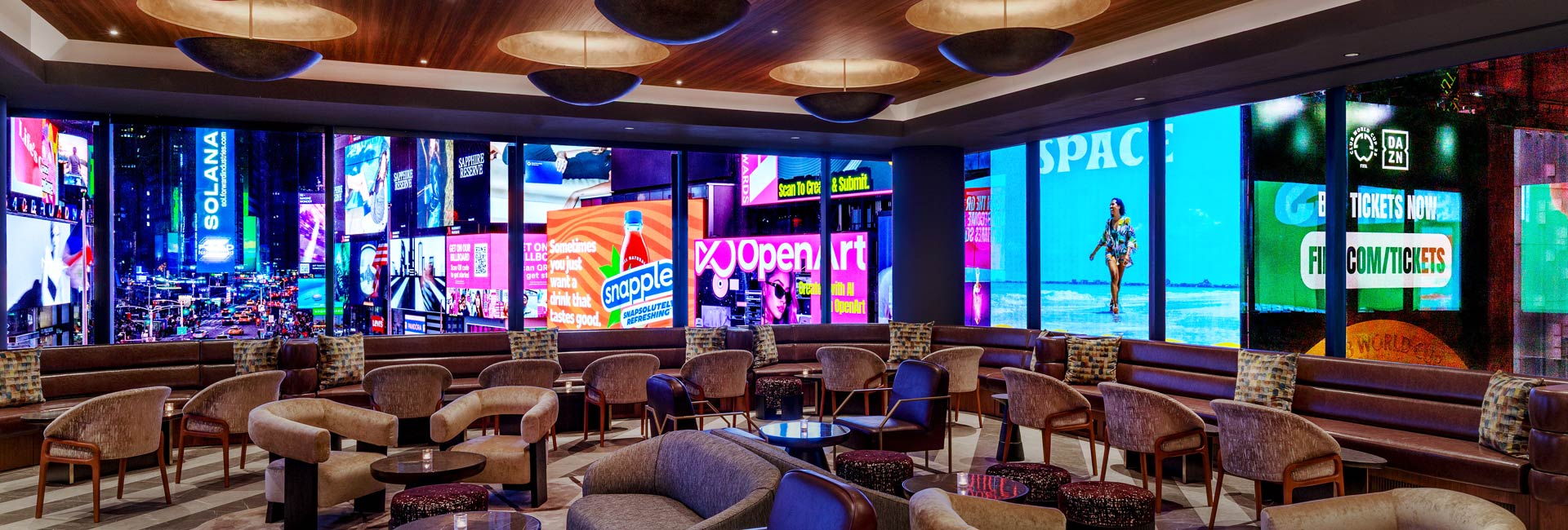 Bowtie Bar lounge offers comfortable seating and panoramic views of Times Square’s illuminated billboards.