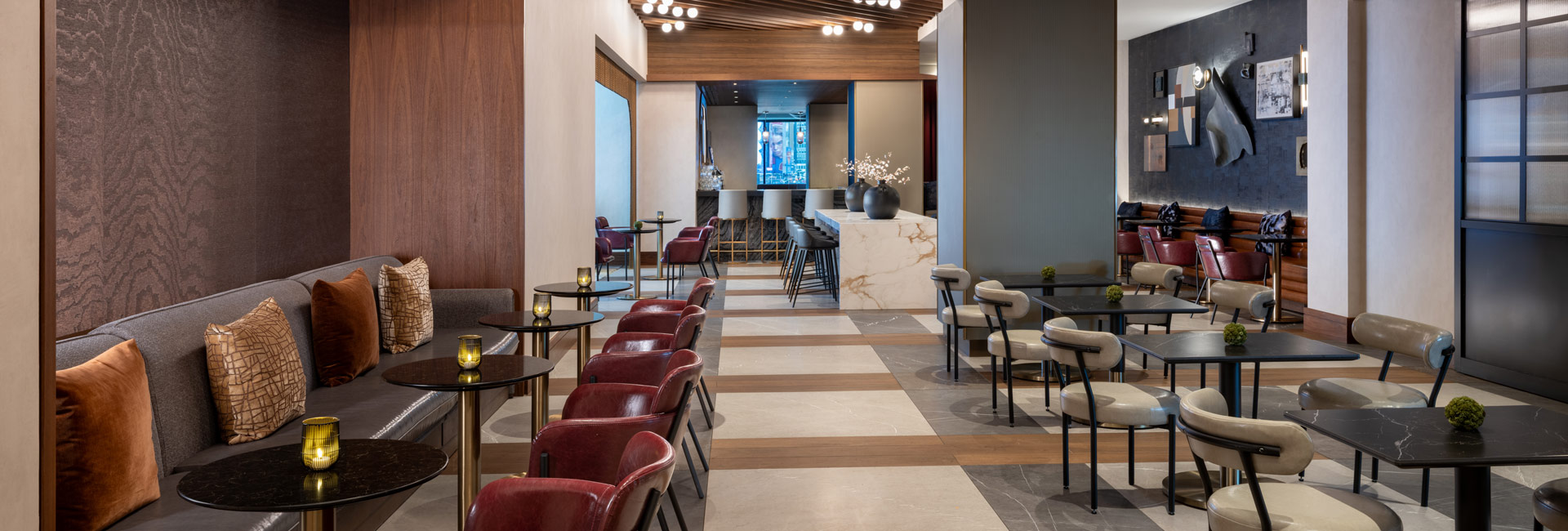 Renovated upper lobby with lounge seating, dining tables, marble accents, wood finishes, and contemporary artwork.