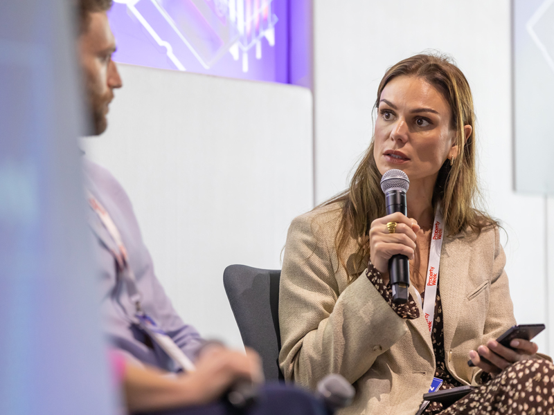 Property Week’s Tech and Innovation Forum Ilka Van Heerden speaking into a handheld microphone during a panel discussion