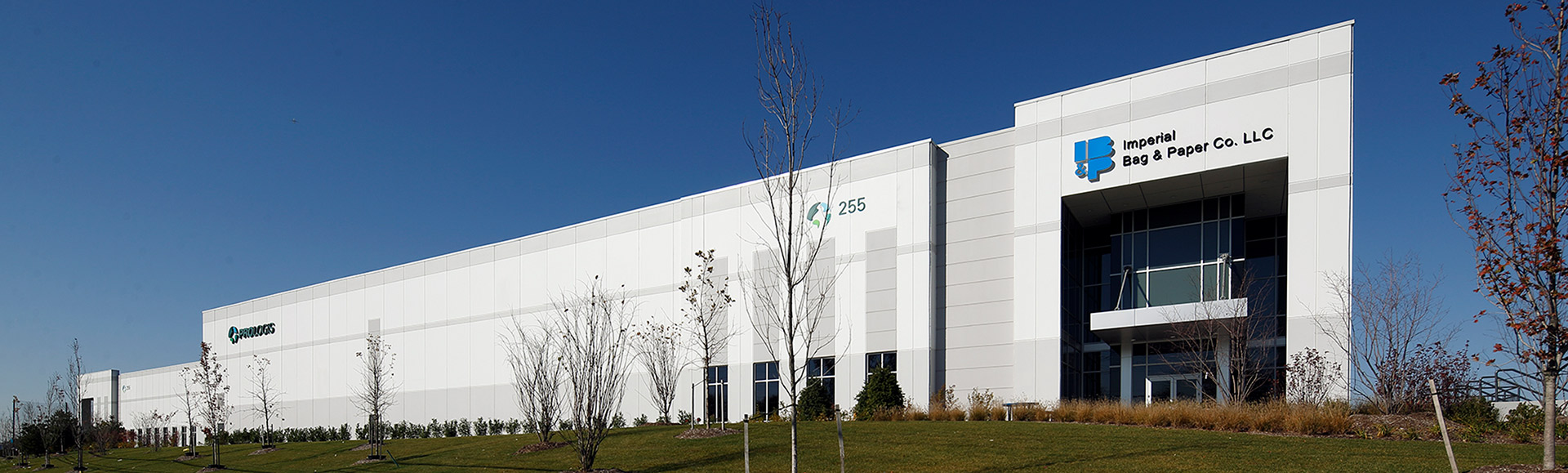 A white building with a blue sign on it.