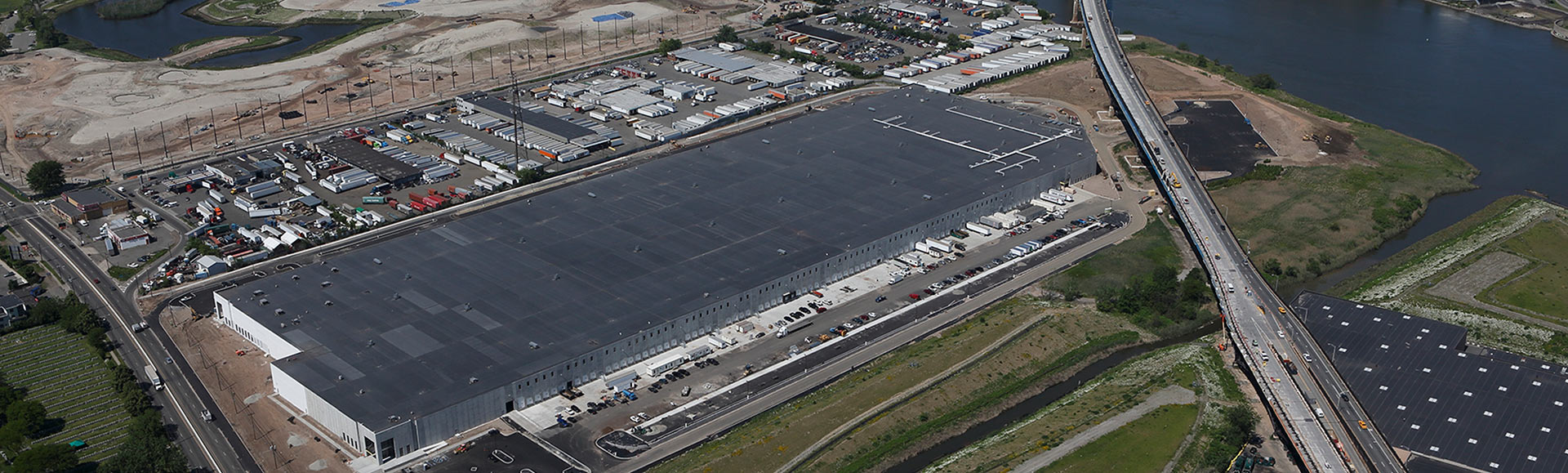 An aerial view of a massive industrial building, showcasing its size and complexity.